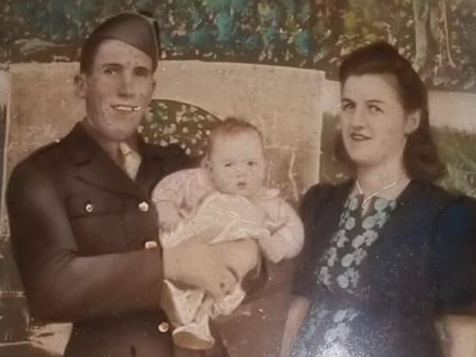 Family photo of Travis Prestridge in his father’s arms, Pfc. Robert T. Prestridge.