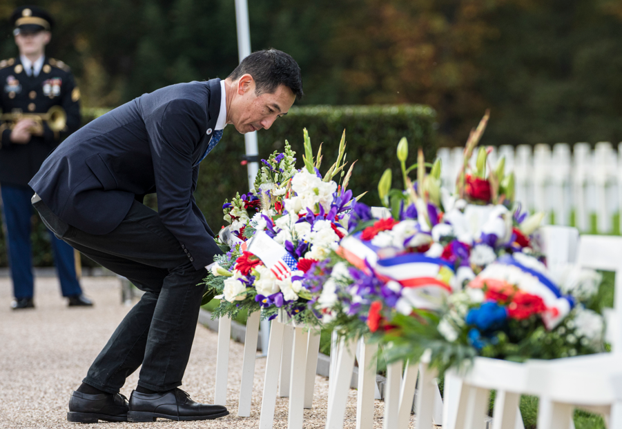 Picture of ABMC Secretary Charles K. Djou laying wreaths on behalf of the city of Honolulu and American Battle Monuments Commission at Epinal American Cemetery.  