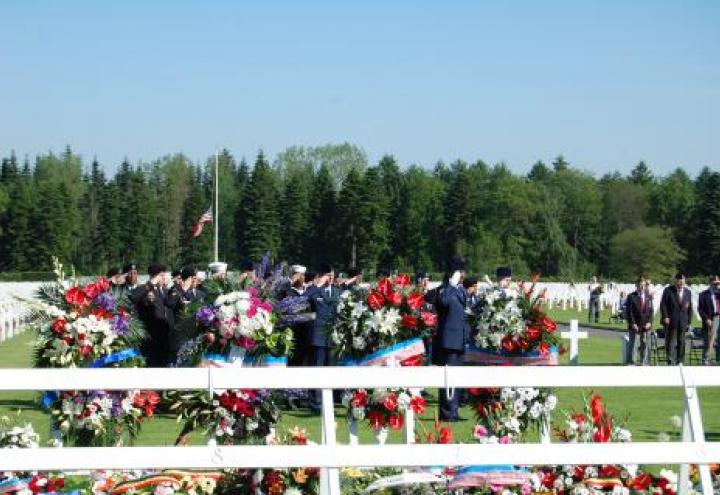 Members of the military salute during the 2012 Memorial Day ceremony at Ardennes American Cemetery.
