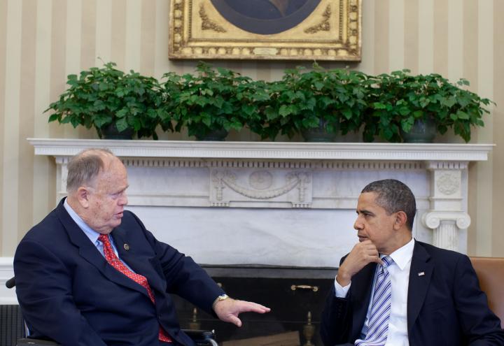 Secretary Cleland sits with President Obama in the Oval Office.