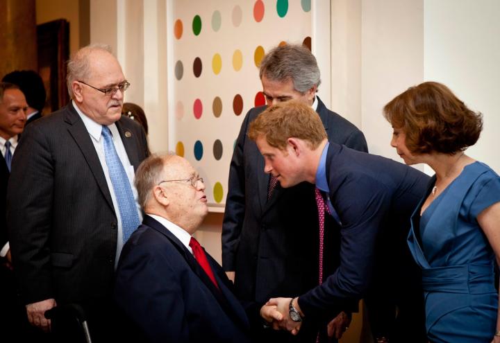 Max Cleland shakes hands with Prince Harry. 