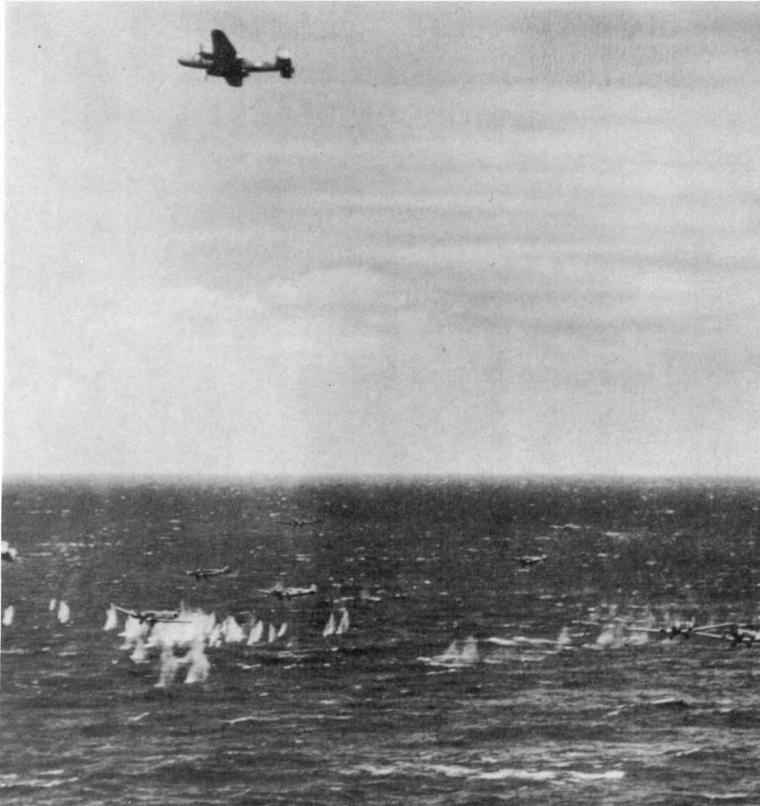 Historic photos shows American bomber attacking German transport planes. 