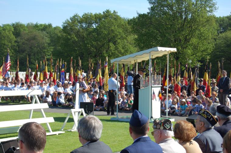 Attendees of 2012 Memorial Day Ceremony look on as superintendent delivers remarks at Ardennes American Cemetery.