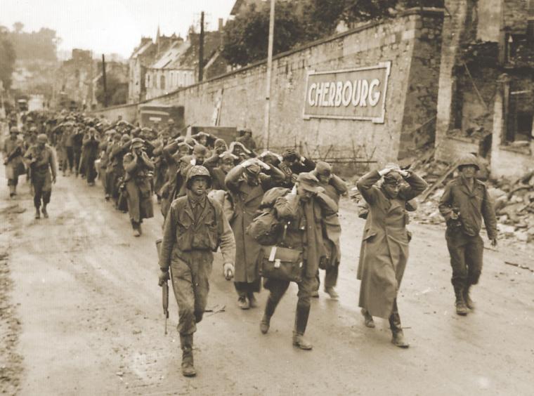 U.S. soldiers escort German prisoners of war, June 28, 1944.